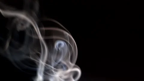 Smoke streaming in the dark from a burning incense stick. Stock Footage 147040314