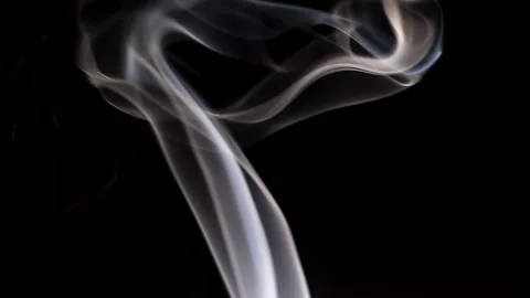 Smoke streaming in the dark from a burning incense stick. Stock Footage 147040357