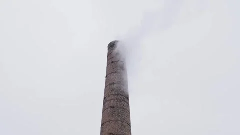 Smoke streams from brick chimney on cloudy day Stock Footage 330429127