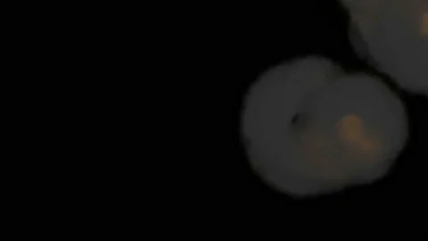 Smoke streams form ring in slow motion view from above. Isolated on black Stock-Footage 113080290