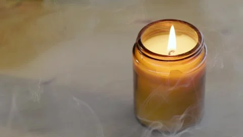 Smoke Swirling Around a Single Burning Candle Close Up Stock Footage 345292596