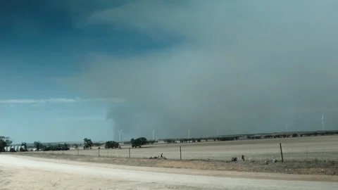 Smoke time-lapse over wind turbine farmland Vídeo Stock 301833933