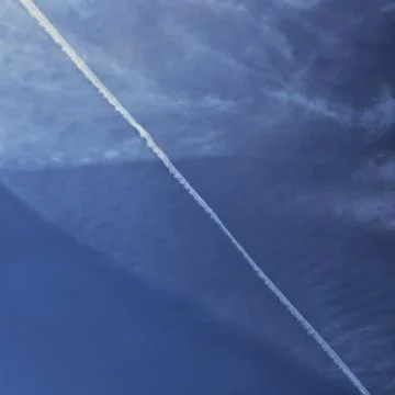 Smoke trail on cloudy sky Foto stock