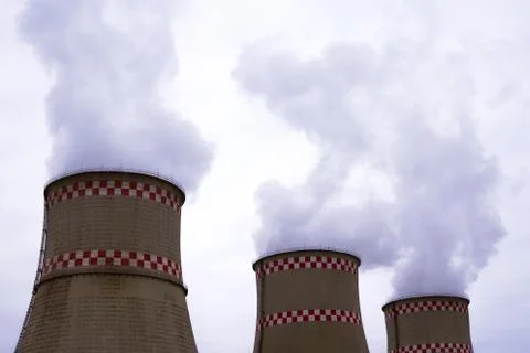 Smoke from two industrial chimneys. Global warming. Air polution. Stock Photos