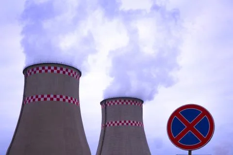 Smoke from two industrial chimneys. Global warming. Air polution. And road sign Stock Photos