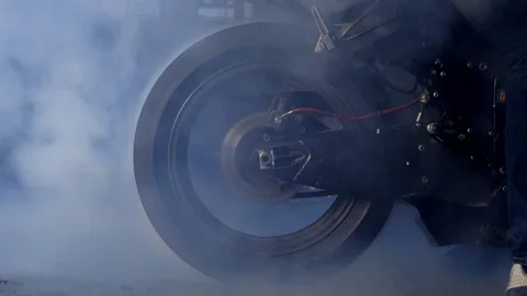 Smoke from under the motorcycle wheels Stock Footage 77828121