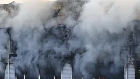 Smoke from the windows of a building burned down in a fire Stock Footage 203242010
