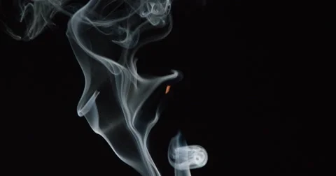 Smoke wisps and billows rise from bottom of frame and curl, slow motion Stock Footage