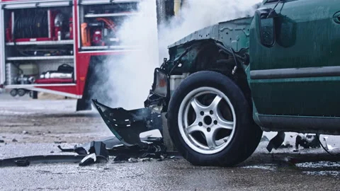 Smoke from wrecked car with fire engine in the background. Car accident Stock Footage 143593622