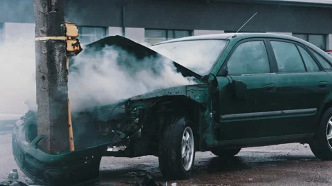 Smoke from wrecked car with fire engine in the background. Car accident Stock Footage 143594101