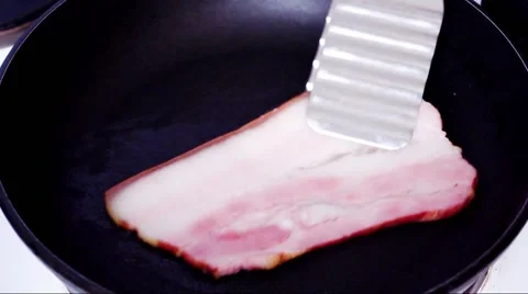 Smoked bacon fried in a pan Stock Footage 46807752