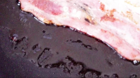 Smoked bacon fried in a pan Stock Footage 46807762
