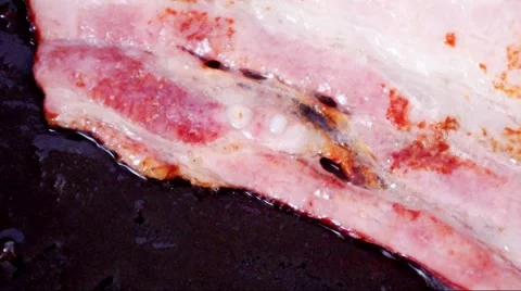 Smoked bacon fried in a pan Stock Footage 46807779