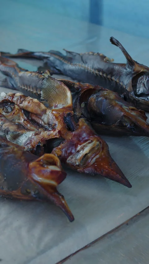 Smoked fish lying on table surface Stock Footage 307860323