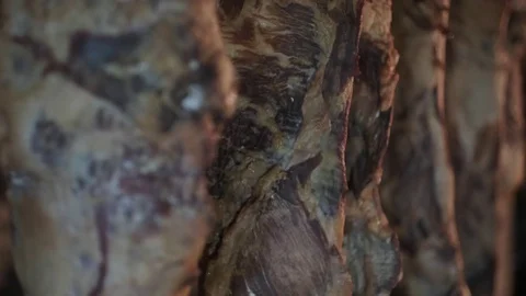 Smoked ham hangs in the dark attic Stock Footage 129198608