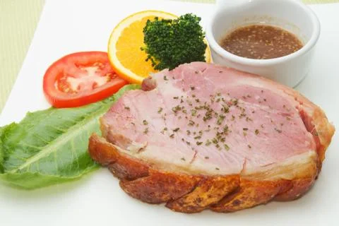 Smoked ham stack with fruit and vegetable salad on the white plate Stock Photos