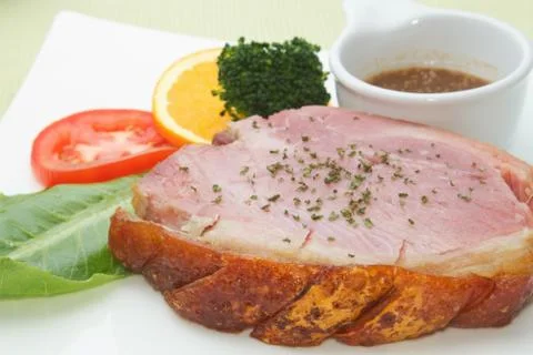 Smoked ham stack  on the white plate Stock Photos