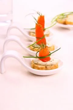 Smoked lachsrollchen on white bread chunks Stock Photos