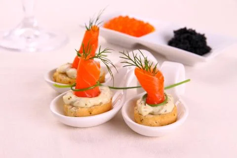 Smoked lachsrollchen on white bread chunks Stock Photos