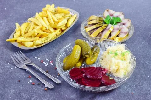 Smoked mackerel, pickled cucumbers, beetroot, sauerkraut, french fries Stock Photos