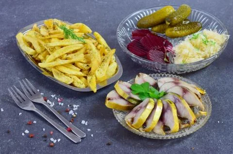 Smoked mackerel, pickled cucumbers, beetroot, sauerkraut, french fries Stock Photos