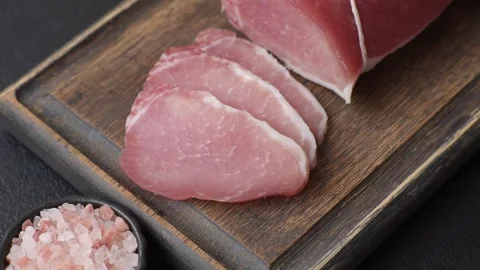 Smoked or dry cured meat slices, pork or ham with salt and spices. Smoked meat s Stock Footage 333073226