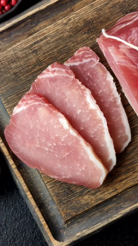 Smoked or dry cured meat slices, pork or ham with salt and spices. Smoked meat s Stock Footage 333073288