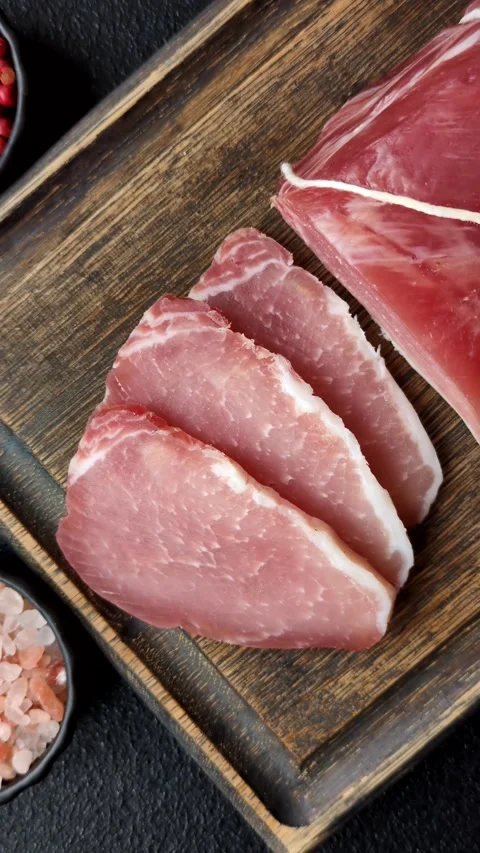 Smoked or dry cured meat slices, pork or ham with salt and spices. Smoked meat s Stock Footage 333073292