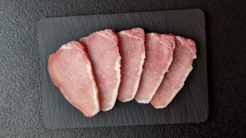 Smoked or dry cured meat slices, pork or ham with salt and spices. Smoked meat s Stock Footage 333073297