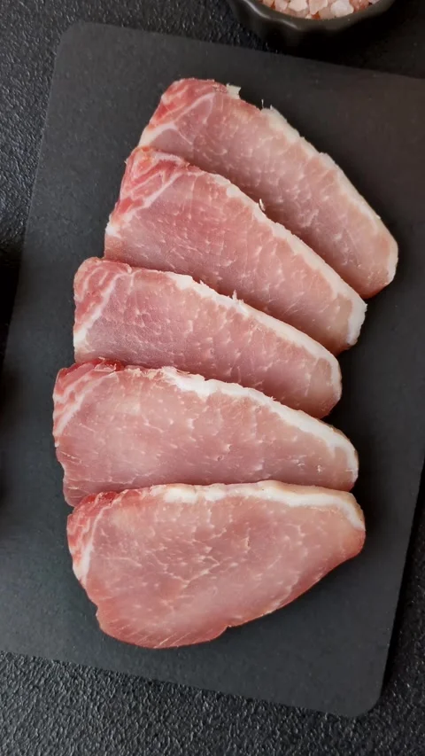 Smoked or dry cured meat slices, pork or ham with salt and spices. Smoked meat s Stock Footage 333073310
