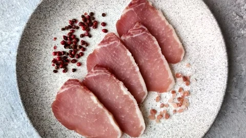 Smoked or dry cured meat slices, pork or ham with salt and spices. Smoked meat s Stock Footage 333073317