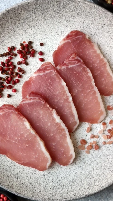 Smoked or dry cured meat slices, pork or ham with salt and spices. Smoked meat s Stock Footage 333073326