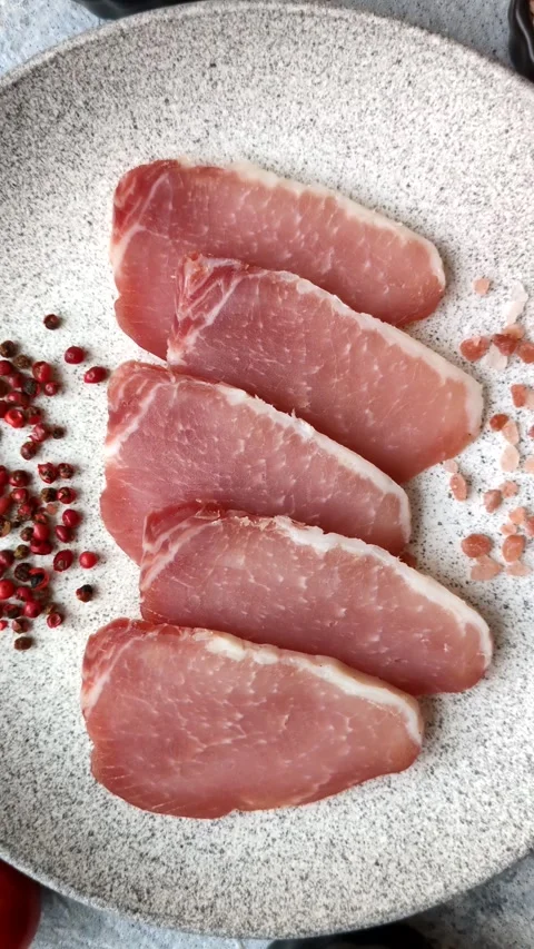 Smoked or dry cured meat slices, pork or ham with salt and spices. Smoked meat s Stock Footage 333073328