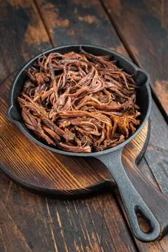 Smoked pulled beef brisket in cast iron skillet, juicy shredded barbecue me.. Stock Photos