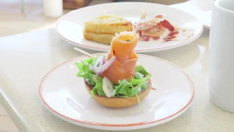 Smoked salmon roll on open face toasted bagel brunch 動画素材 338202336