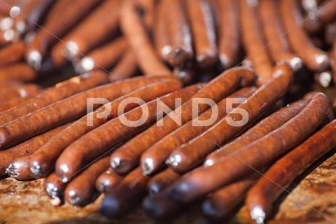 Smoked sausage background at the fair Stock Photos