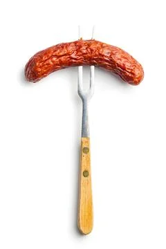 Smoked sausage pricked on a fork. Stock Photos