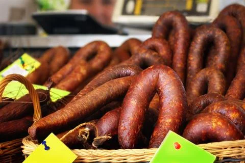 Smoked sausages in baskets with price tags Stock Photos