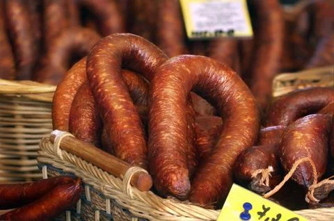 Smoked sausages in baskets with price tags Stock Photos