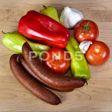 Smoked sausages with vegetables Stock Photos