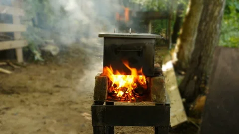Smokehouse on a burning campfire in the yard Stock Footage 160125519