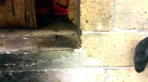 Smoker box, surrounded by fire, inside a wooden heated oven, at a restaurant  Stock Footage 57676107