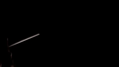 The smoker sets fire to a cigarette and smokes exhaling smoke. Stock Footage 117523855