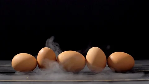 Smoker in slow motion on black background and eggs Stock-Footage 112429986