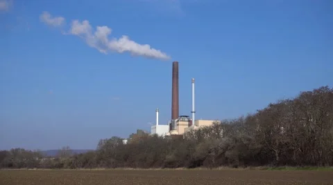Smokestack against blue sky Stock Footage 61908643