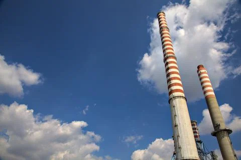 Smokestacks with a clear sky as backdrop Stock Photos