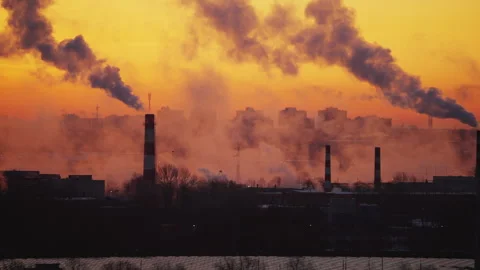 Smokestacks Release Thick Smoke Over City at Sunrise Video stock 327459319