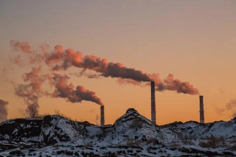 Smokestacks at sunset 스톡 사진
