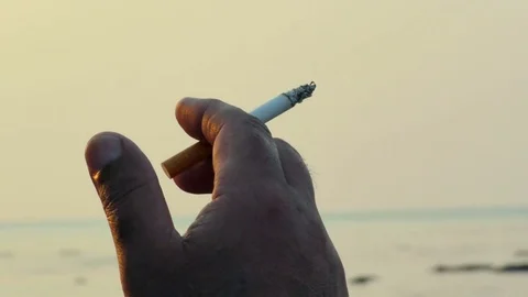 Smoking on the background of the sea Stock Footage 77441506