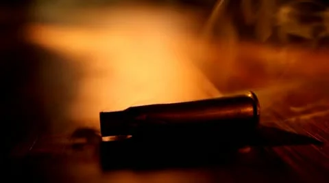 Smoking Bullet on Table Video HD Stock Footage 22149677